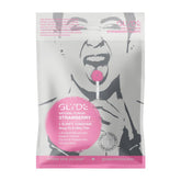 A pack of Glyde SlimFit Strawberry Flavored Condoms 🍓 features an image of a person playfully holding a pink lollipop. The package highlights their ultra-thin, sheer, silky texture, lubricated finish, and paraben-free formula.